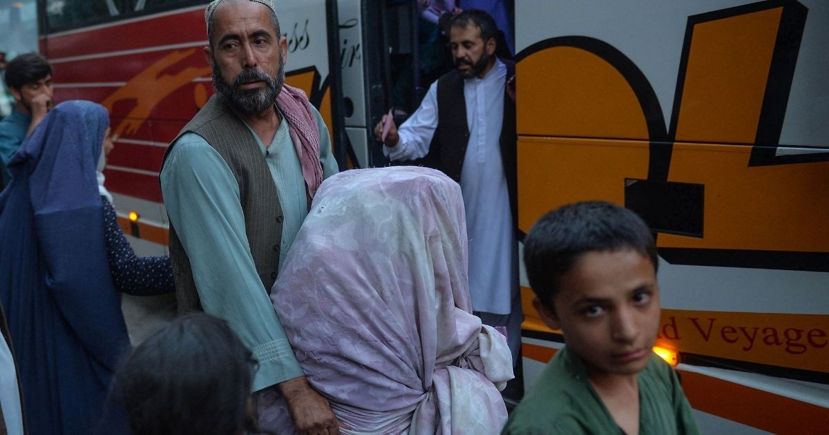 Refugees wait to board a bus in Kabul, Afghanistan, on Sept. 29.