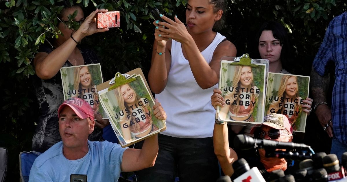 Gabby Petito supporters hold signs during a news conference in North Port, Florida, on Wednesday.