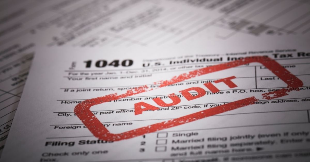 A stock photo shows a red stamp on a 1040 US individual income tax return.