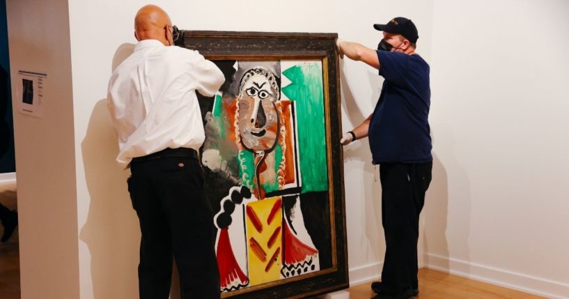 Jose Reynoso and Terence McAllister lift a still life painting by Pablo Picasso titled "Buste d'Homme" at the Bellagio Gallery of Fine Art in Las Vegas on Tuesday.