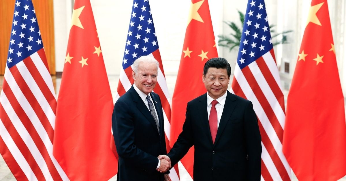Then-Vice President Joe Biden and Chinese President Xi Jinping shake hands inside the Great Hall of the People in Beijing on Dec. 4, 2013.