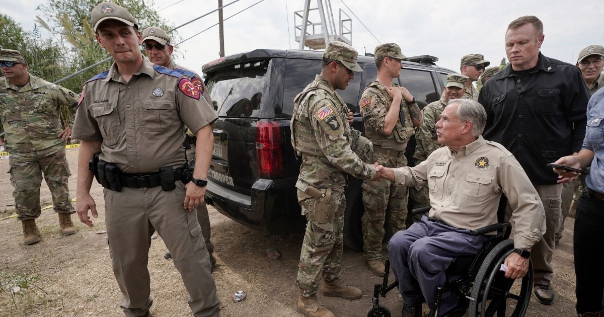 Texas Gov. Greg Abbott shakes a National Guard member's hand after a Sept. 21 news conference in in Del Rio, Texas.