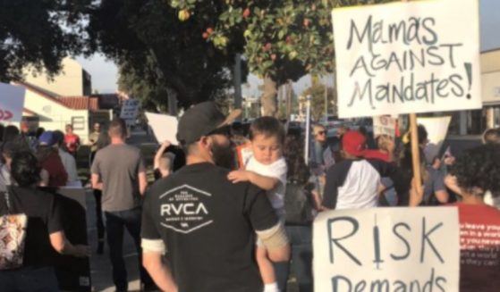Parents protesting coronavirus vaccine mandates demonstrate outside the meeting site for the Riverside Unified Board of Education in Riverside, California, on Thursday.
