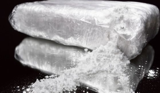 A stock photo shows a torn bag of cocaine.