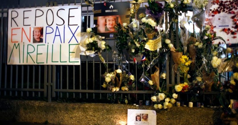 A March 28, 2018 photo shows flowers and placards adorn the outside of Mireille Knoll's apartment in Paris, France.