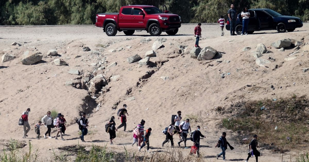 Migrants try to enter the U.S. from Mexico at the border in San Luis, Arizona, on Oct. 10.