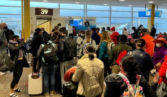 Crowds are seen at Reagan Washington National Airport on Dec. 18, 2020. American Airlines has become the latest airline to cancel a large number of flights.
