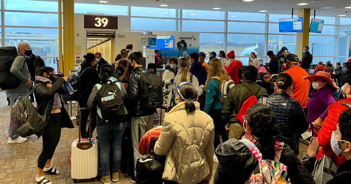 Crowds are seen at Reagan Washington National Airport on Dec. 18, 2020. American Airlines has become the latest airline to cancel a large number of flights.