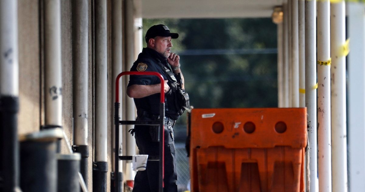 Memphis Police Department officers examine the scene outside the post office in Memphis, Tennessee, on Tuesday.