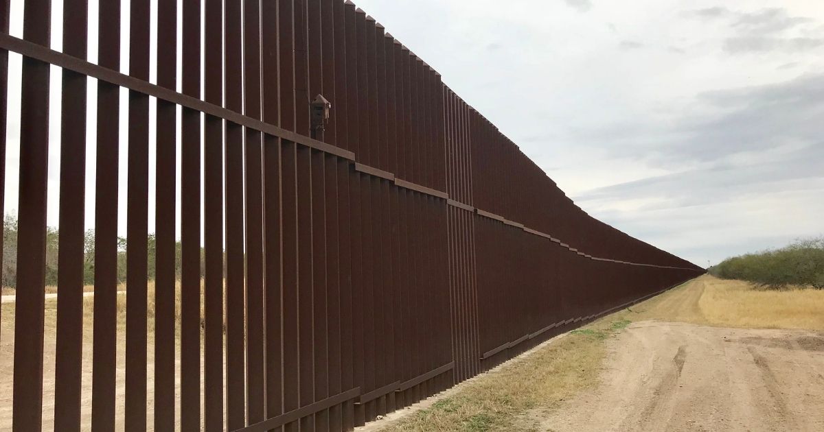 A stock photo shows the U.S./Mexico border wall on the Texas border.