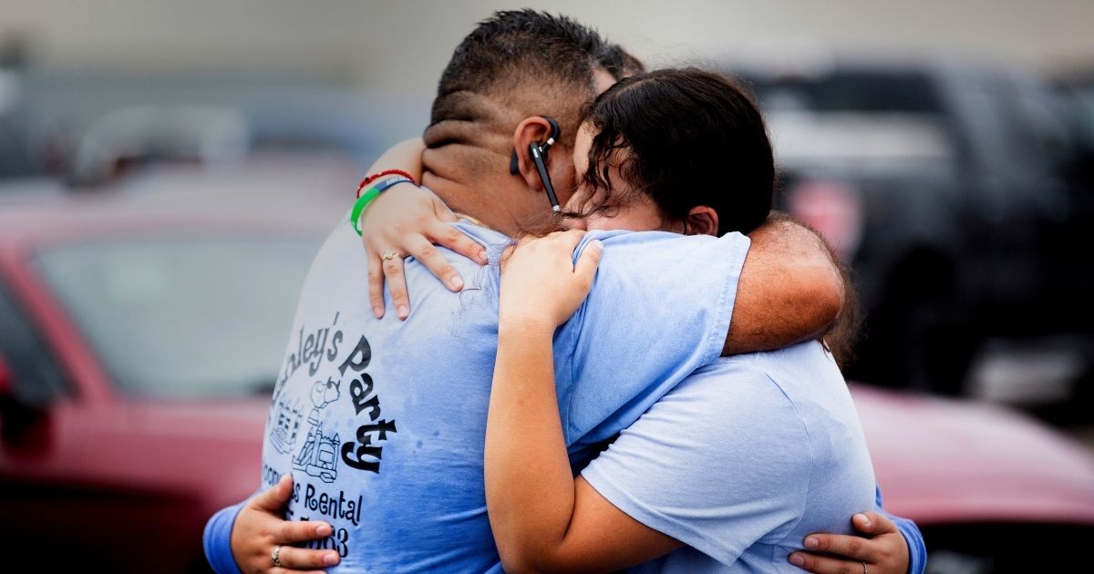 An eighth-grade student at YES Prep Southwest Secondary school in Houston is seen hugging her father on Friday.