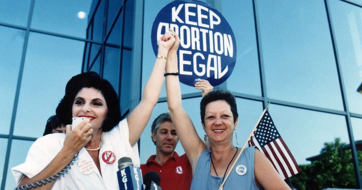 Attorney Gloria Allred, left, stands with "Jane Roe" plaintiff Norma McCorvey in Burbank, California, on July 4, 1989.