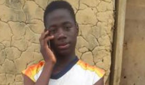 Emmanuel Tuloe speaks on his phone in Gbolor Dialla, Liberia, on Thursday.