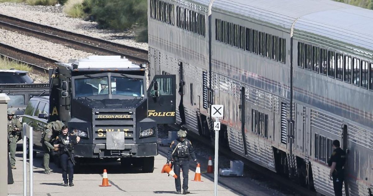 A Tucson Police Department SWAT truck is seen beside two Amtrak train cars in downtown Tucson, Arizona, on Monday.