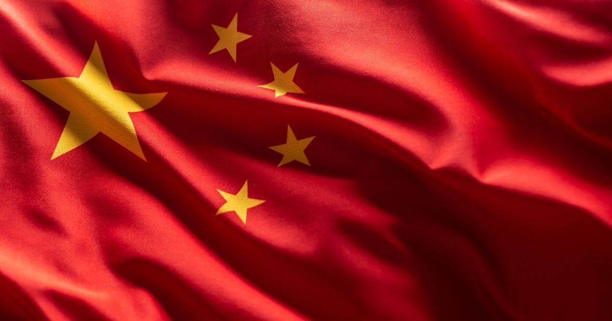 A stock photo shows the Chinese flag blowing in the wind.