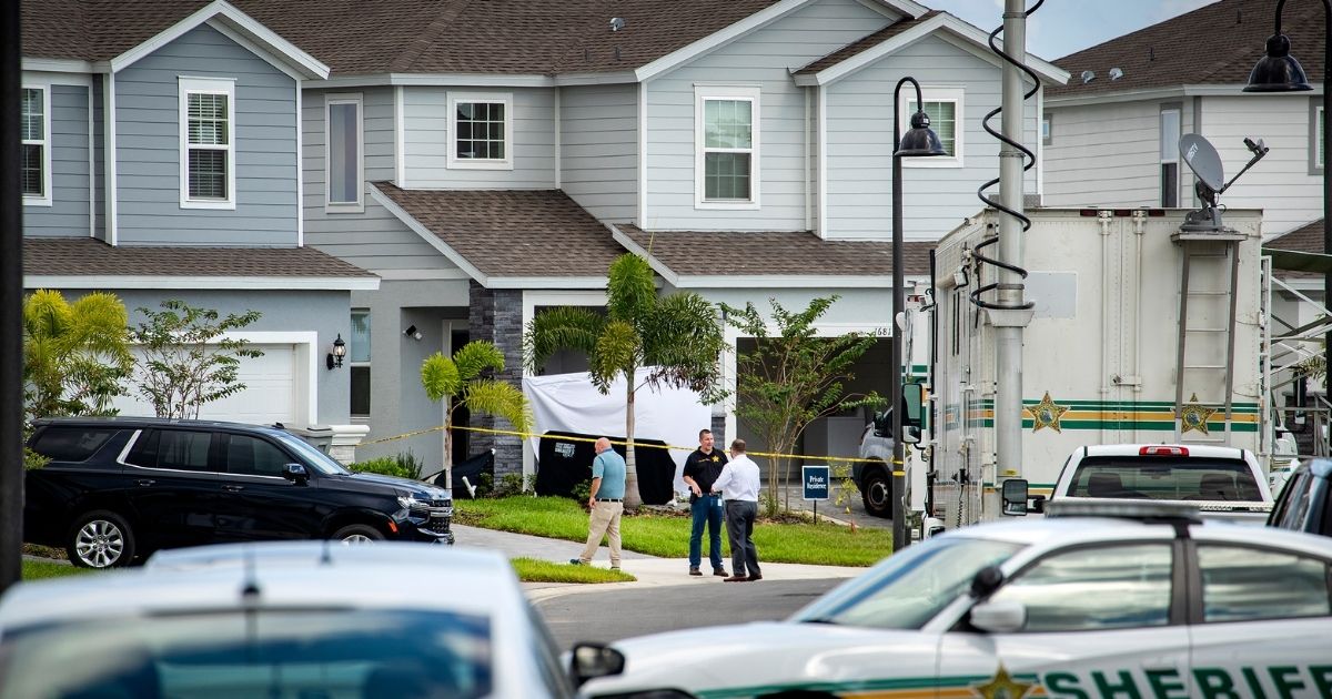 Polk County Sheriff’s investigators are seen investigating the crime scene in Davenport, Florida, on Saturday.