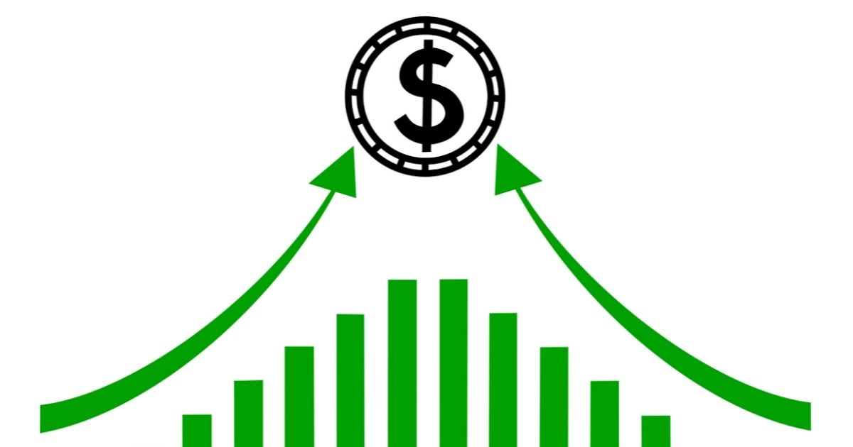 A stock photo shows arrows pointing up at a dollar coin.