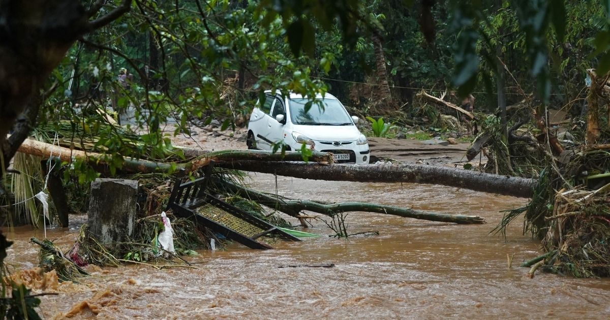 A car is stuck in murky water due to flash floods at Thodupuzha in India's Kerala state on Saturday.