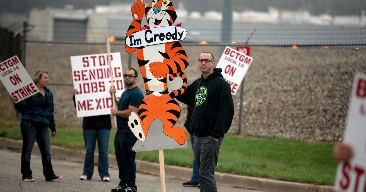 First shift worker Travis Huffman and other BCTGM Local 3G union members are seen striking outside the Kellogg plant in Battle Creek, Michigan, on Tuesday.