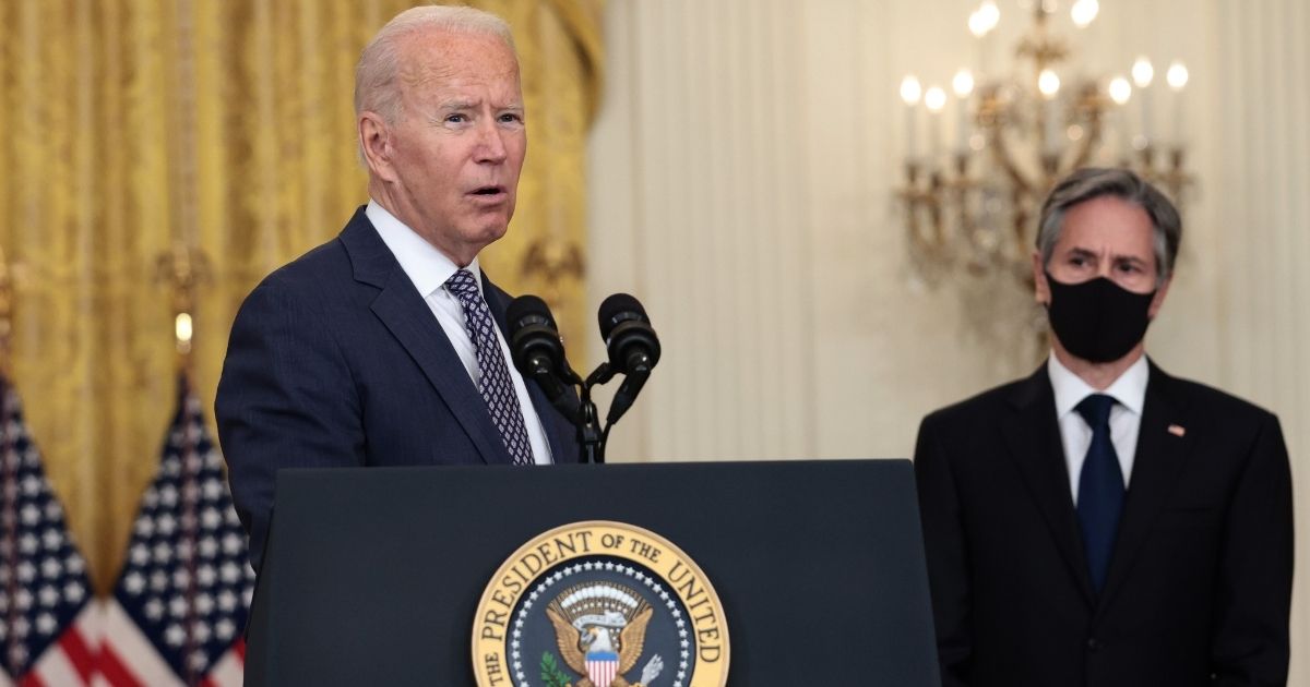 President Joe Biden stands with Secretary of State Antony Blinken while delivering remarks from the East Room of the White House in Washington, D.C., on Aug. 20.