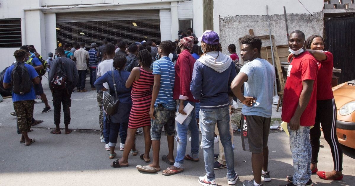 Haitian migrants wait to enter the National Commission for Refugees offices to ask for asylum in Monterrey, Mexico, on Sept. 27.