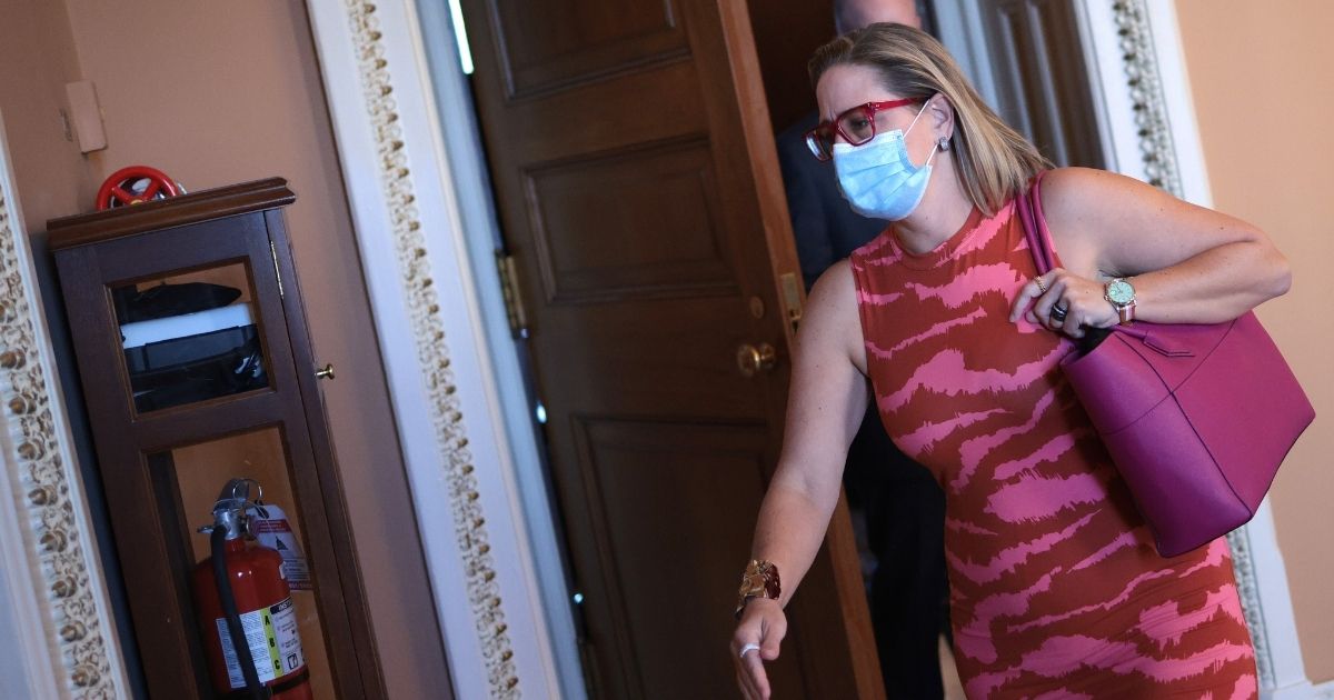 Arizona Sen. Kyrsten Sinema leaves a Democratic luncheon before heading to the U.S. Senate chamber at the U.S. Capitol on Sept. 30, in Washington, D.C.