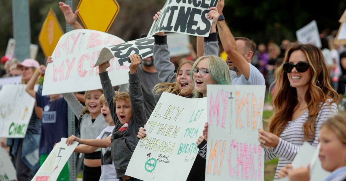 Protesters rally outside of the San Diego Unified School District office in opposition to a vaccination mandate for students on Sept. 28 in San Diego.