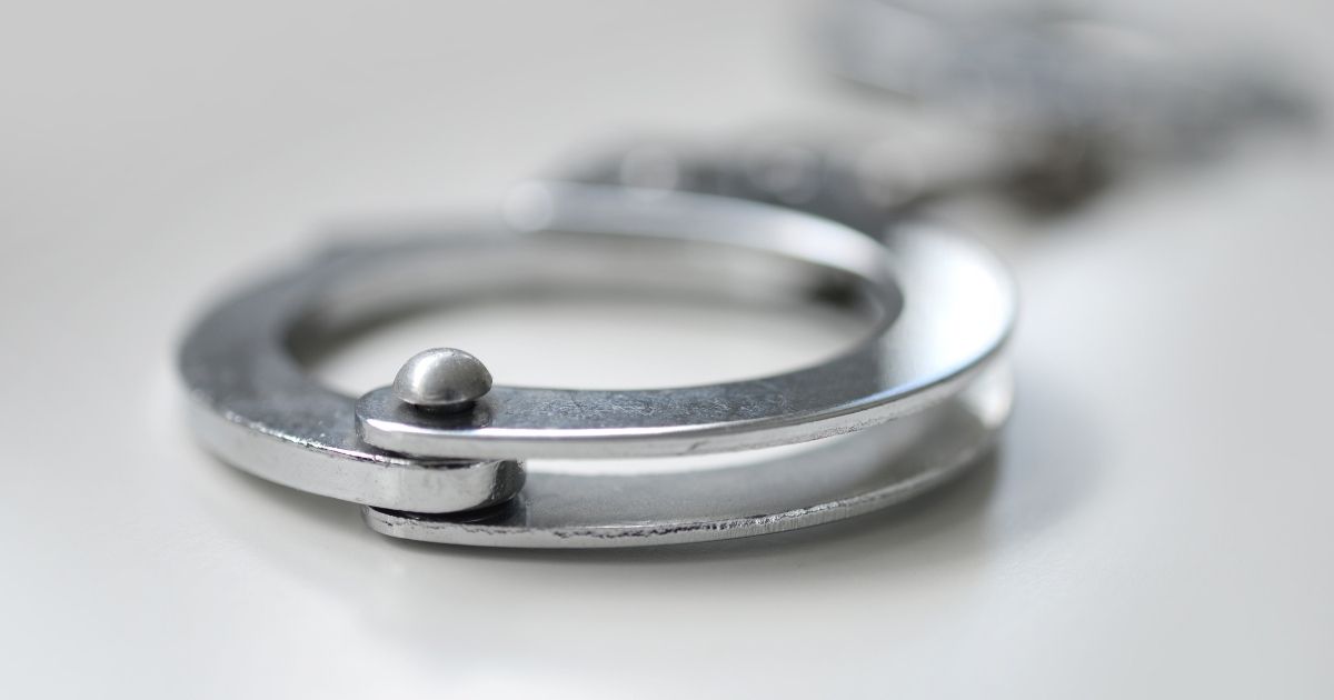 A stock photo shows a pair of police handcuffs.