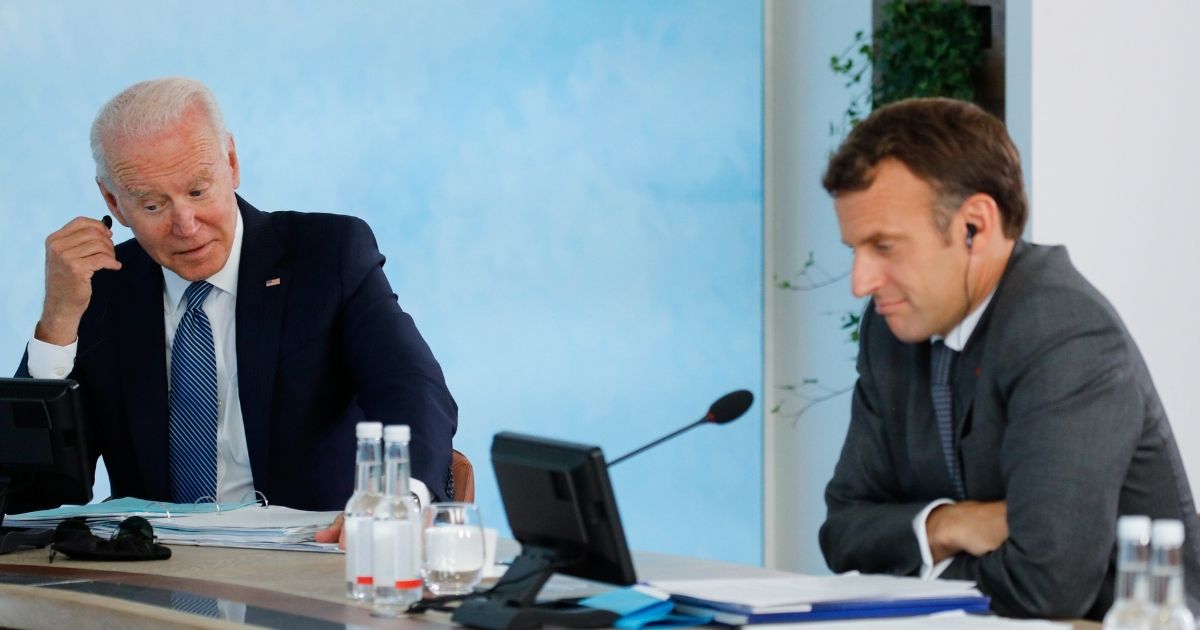 President Joe Biden, left, and French President Emmanuel Macron, right, are seen attending a plenary session during the G7 Summit in Carbis Bay in Cornwall, United Kingdom, on June 13.