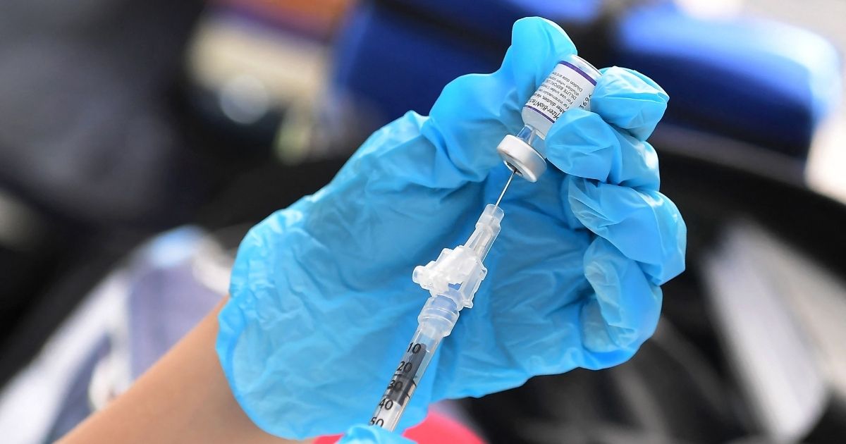 The Pfizer COVID-19 vaccine is prepared for administration at a vaccination clinic for homeless people hosted by the Los Angeles County Department of Public Health and United Way on Sept. 22 in Los Angeles.