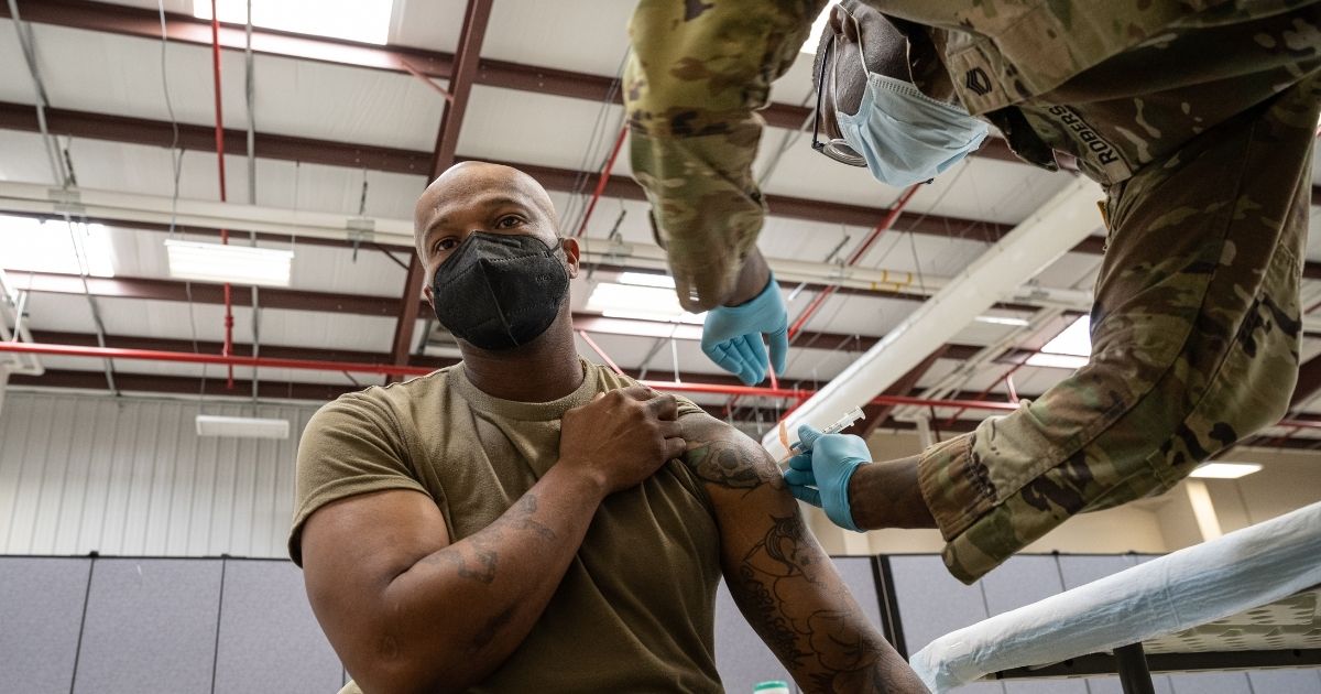 Preventative Medicine Services NCOIC Sergeant First Class Demetrius Roberson administers a COVID-19 vaccine to a soldier on Sept. 9, 2021 in Fort Knox, Kentucky.