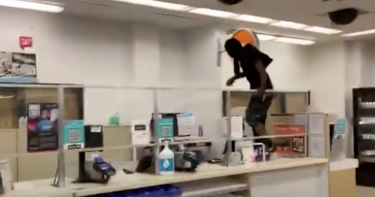 A shoplifter jumps over the counter in a San Francisco Walgreens during the height of the pandemic last October.