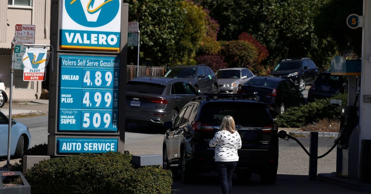 A customer pumps gas at a Valero station on Oct. 12 in San Francisco.