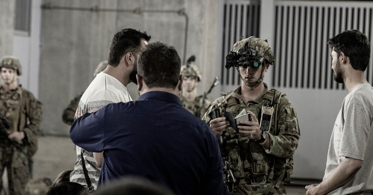 U.S. soldiers with the 82nd Airborne Division assist evacuees at Hamid Karzai International Airport in Kabul, Afghanistan, on Aug. 25.