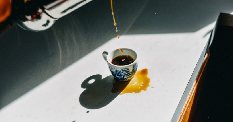 A cup of coffee being poured.