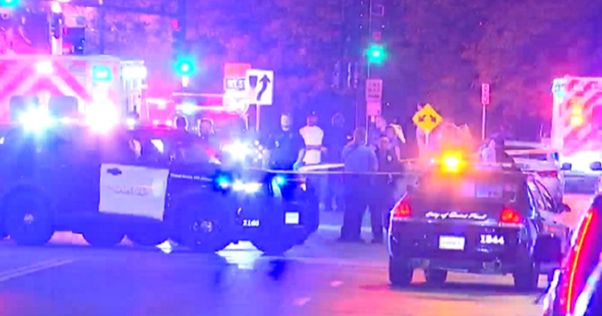 Police respond to the scene of a shooting early Sunday in St. Paul, Minnesota, that left one woman dead and 13 wounded.