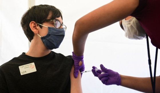 A boy receives a COVID-19 vaccine at Abraham Lincoln High School in Los Angeles on May 13.