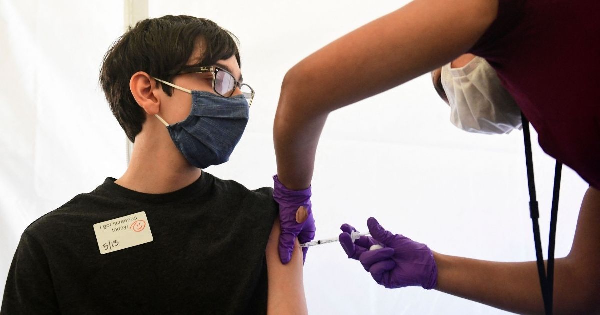 A boy receives a COVID-19 vaccine at Abraham Lincoln High School in Los Angeles on May 13.