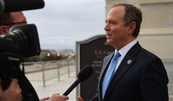 Democratic Rep. Adam Schiff of California talks with a reporter as he arrives at the U.S. Capitol ahead of a vote to extend the federal debt limit until December on Oct. 12 in Washington, D.C.