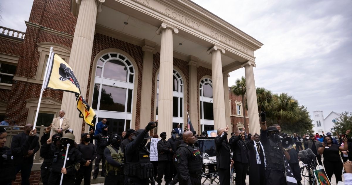 Dozens of Black Lives Matter and Black Panther protesters gather outside the Glynn County Courthouse where the trial of Travis McMichael, his father, Gregory McMichael, and William "Roddie" Bryan is held on Monday in Brunswick, Georgia.