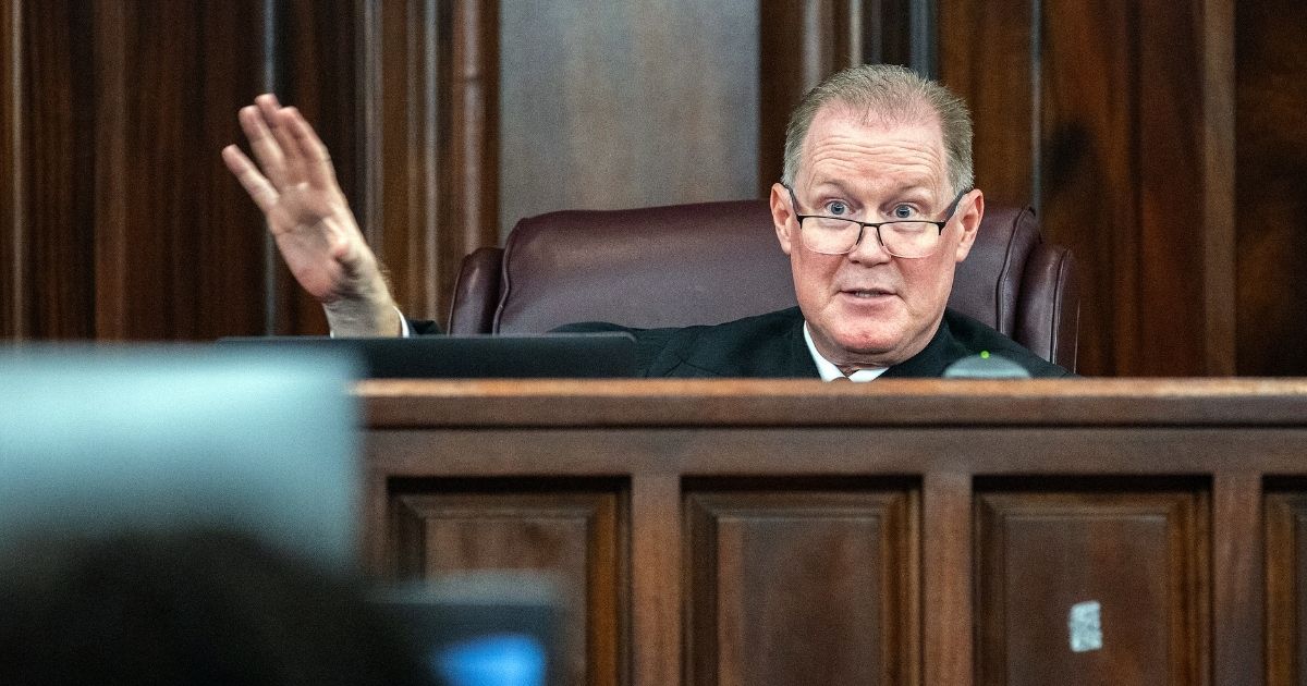 Superior Court Judge Timothy Walmsley speaks with attorneys before the start of closing statements during the trial of Ahmaud Arbery's alleged killers at Glynn County Superior Court on Monday in Brunswick, Georgia.