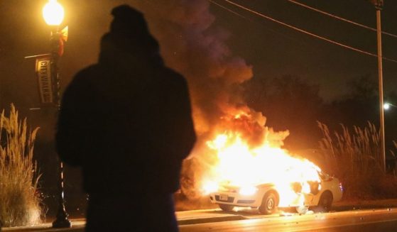 A St. Louis County police car burns after being set on fire by demonstrators during a protest following the grand jury announcement on Nov. 24, 2014, in Ferguson, Missouri.