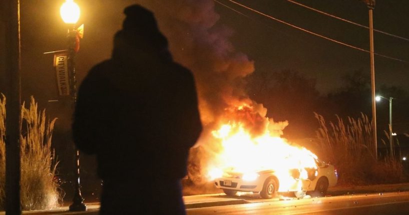 A St. Louis County police car burns after being set on fire by demonstrators during a protest following the grand jury announcement on Nov. 24, 2014, in Ferguson, Missouri.