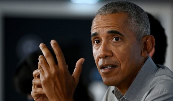 Former President Barack Obama gestures as he speaks during a round table meeting at the University of Strathclyde on Monday in Glasgow, Scotland.