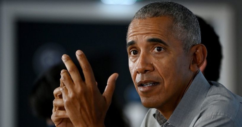 Former President Barack Obama gestures as he speaks during a round table meeting at the University of Strathclyde on Monday in Glasgow, Scotland.