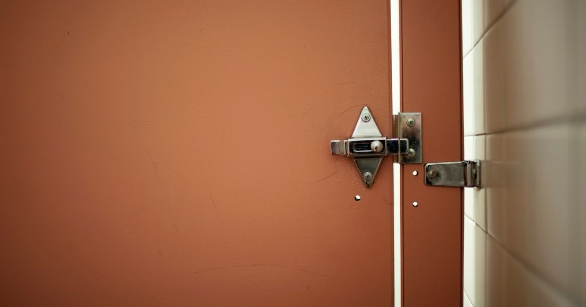 This stock image shows a bathroom stall door. In 2015, the family of two young boys was dining at a Jacksonville, Florida, McDonald’s when a traumatizing incident occurred.