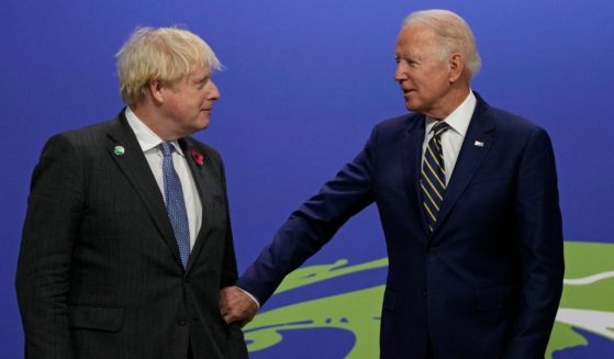 British Prime Minister Boris Johnson, left, greets U.S. President Joe Biden as he arrives for day two of COP26 at SECC on Monday in Glasgow, Scotland.