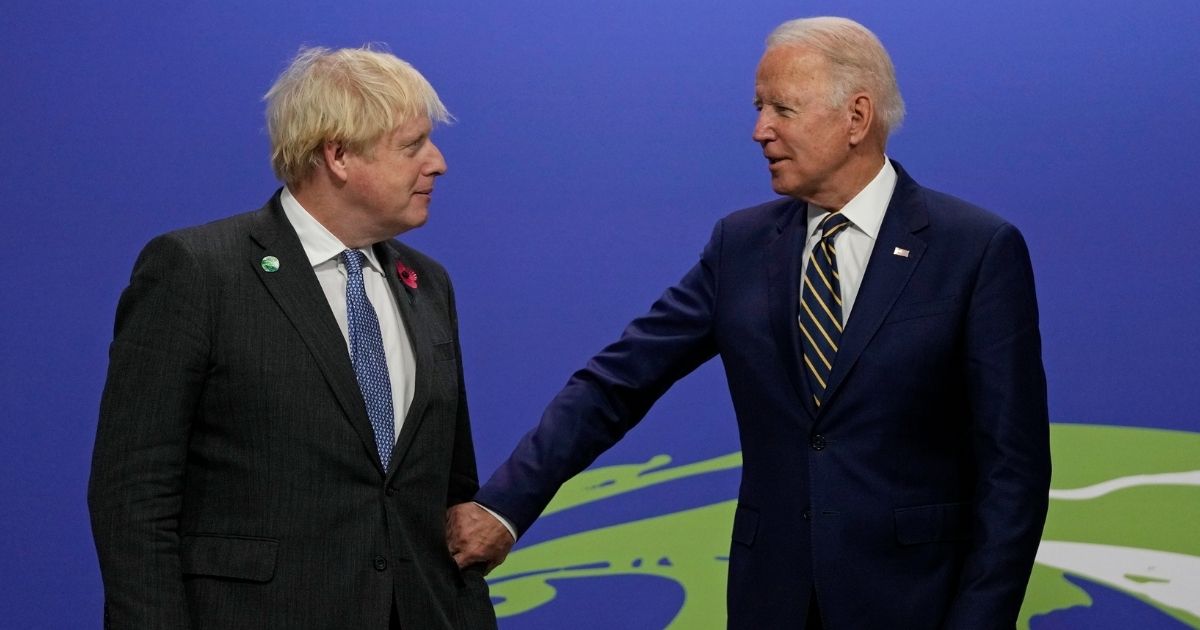 British Prime Minister Boris Johnson, left, greets U.S. President Joe Biden as he arrives for day two of COP26 at SECC on Monday in Glasgow, Scotland.