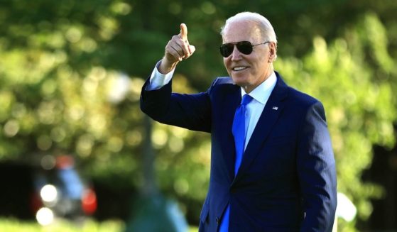 President Joe Biden points to staff members from the South Lawn as he departs the White House on June 25 in Washington, D.C.