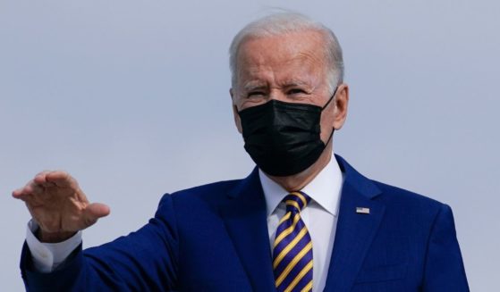 President Joe Biden wears a face mask as he boards Air Force One at Andrews Air Force Base in Maryland on Tuesday.